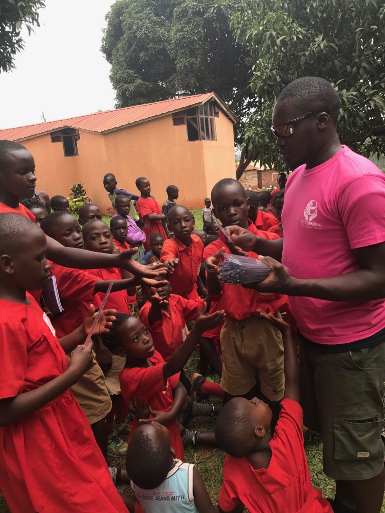 Needy school kids receiving pens and pencils