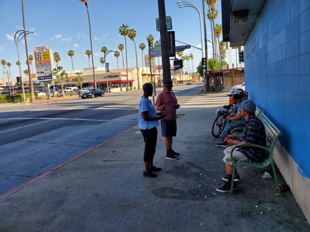 Handing face masks to homeless people in Los Angeles